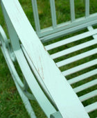 White metal bench on grass