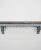Worn wooden shelf with scalloped edge on a white background