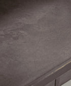Close-up of a textured dark gray surface with a metallic edge.