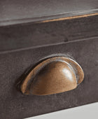 Close-up of a brown handle on a dark surface