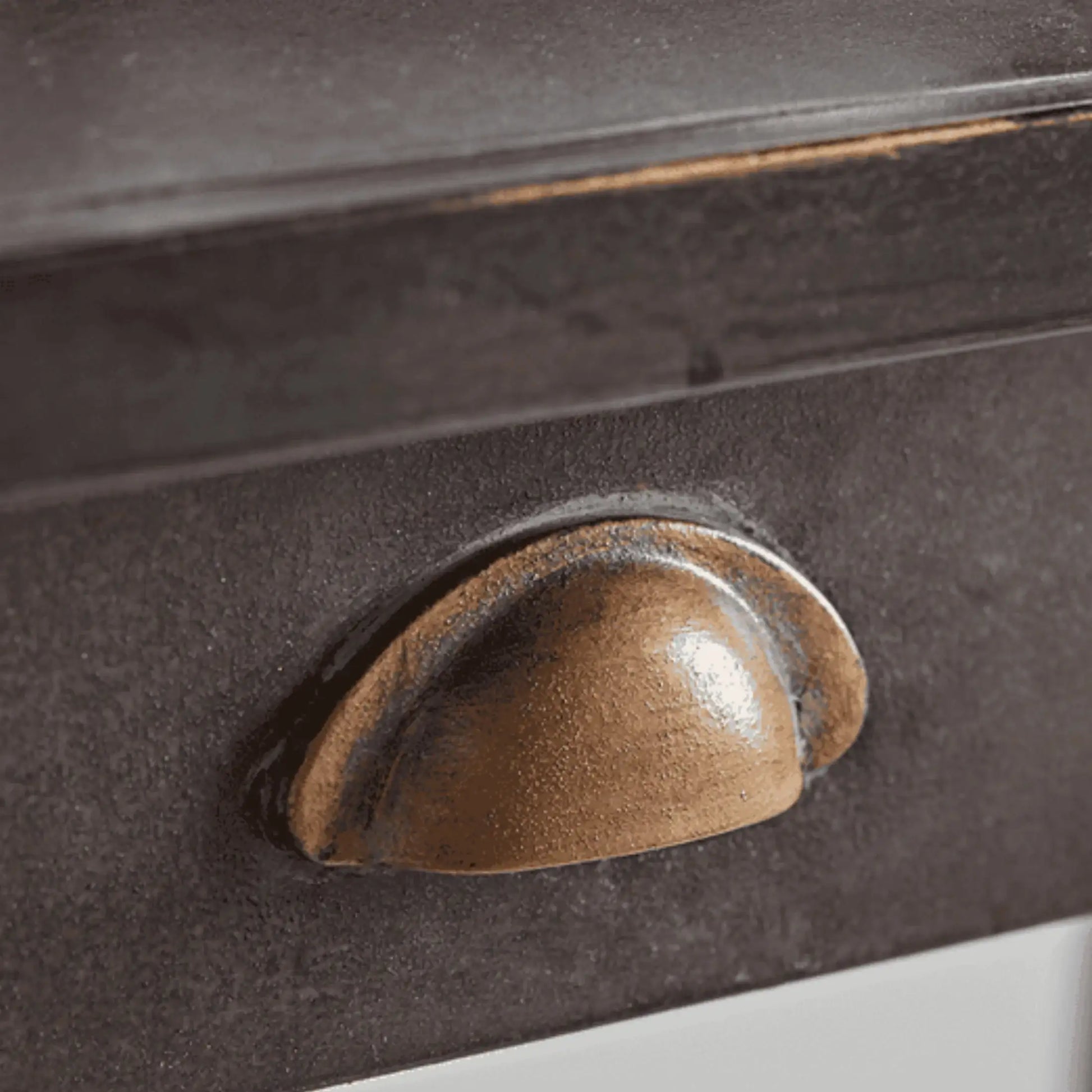 Close-up of a brown handle on a dark surface