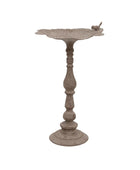 Decorative metal bird bath on a white background