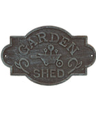 Decorative metal sign with 'Garden Shed' text and a wheelbarrow illustration on a white background.