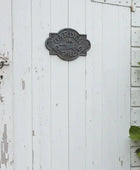 Weathered white wooden door with a metal 'Garden Shed' sign.