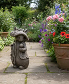 Gnome statue in a garden with flowers and plants