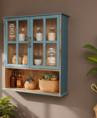 Wooden cabinet with glass doors displaying various items against a brown wall.