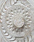 Close-up of a decorative stone wall with intricate carvings.