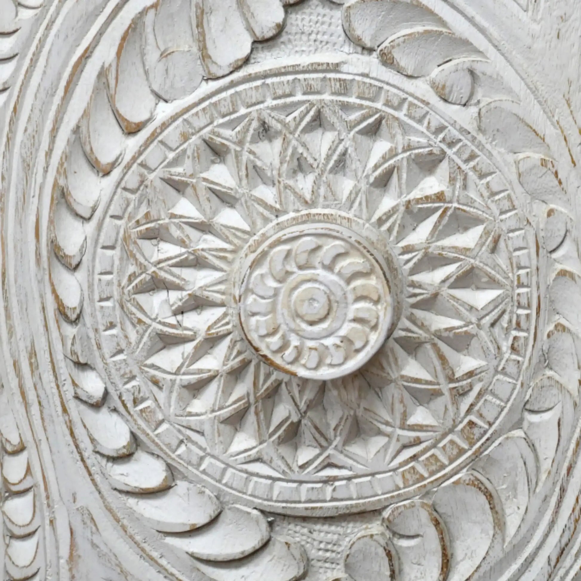Close-up of a decorative stone wall with intricate carvings.