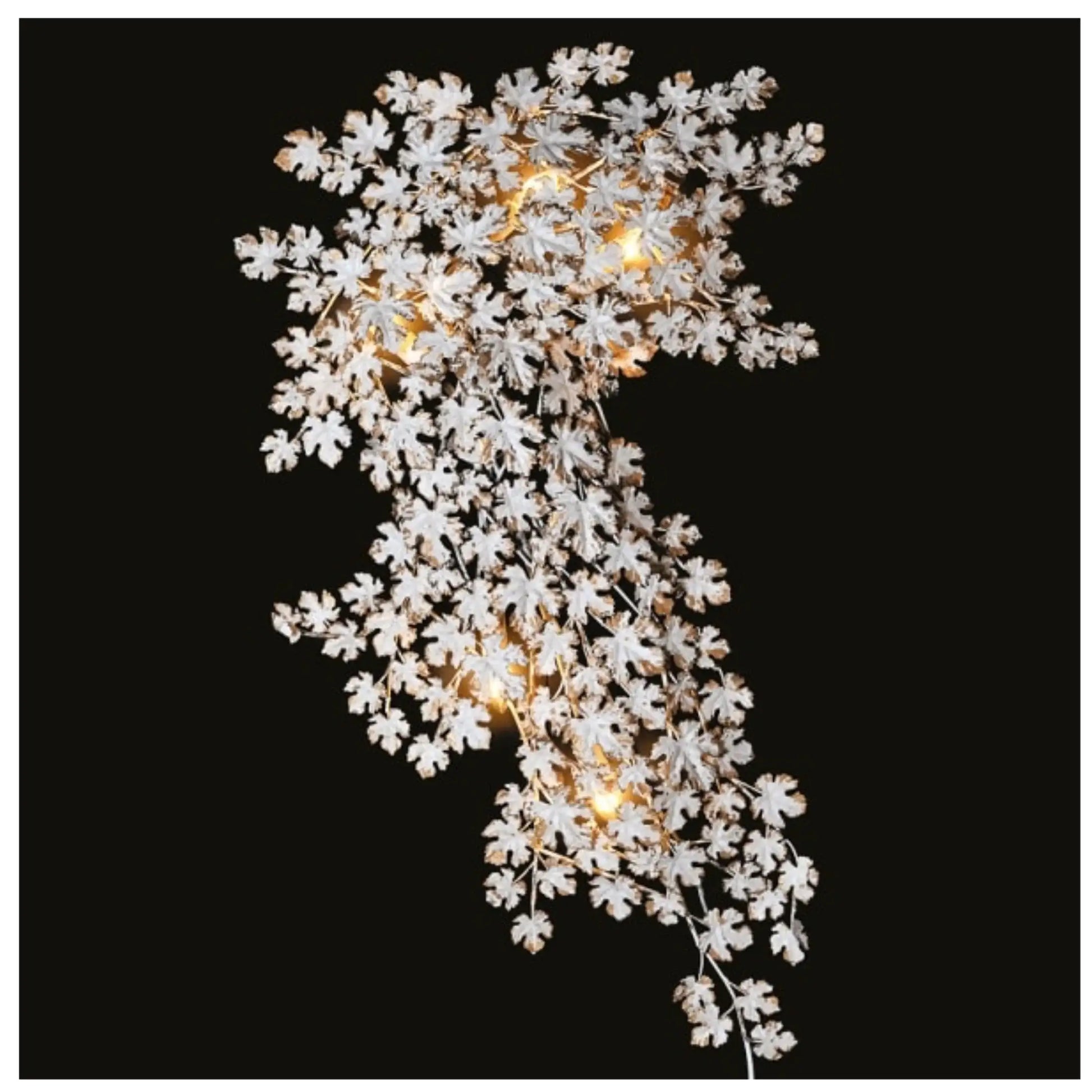 Decorative light fixture with white floral design on a black background