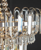 Close-up of a crystal chandelier with clear and gold accents.