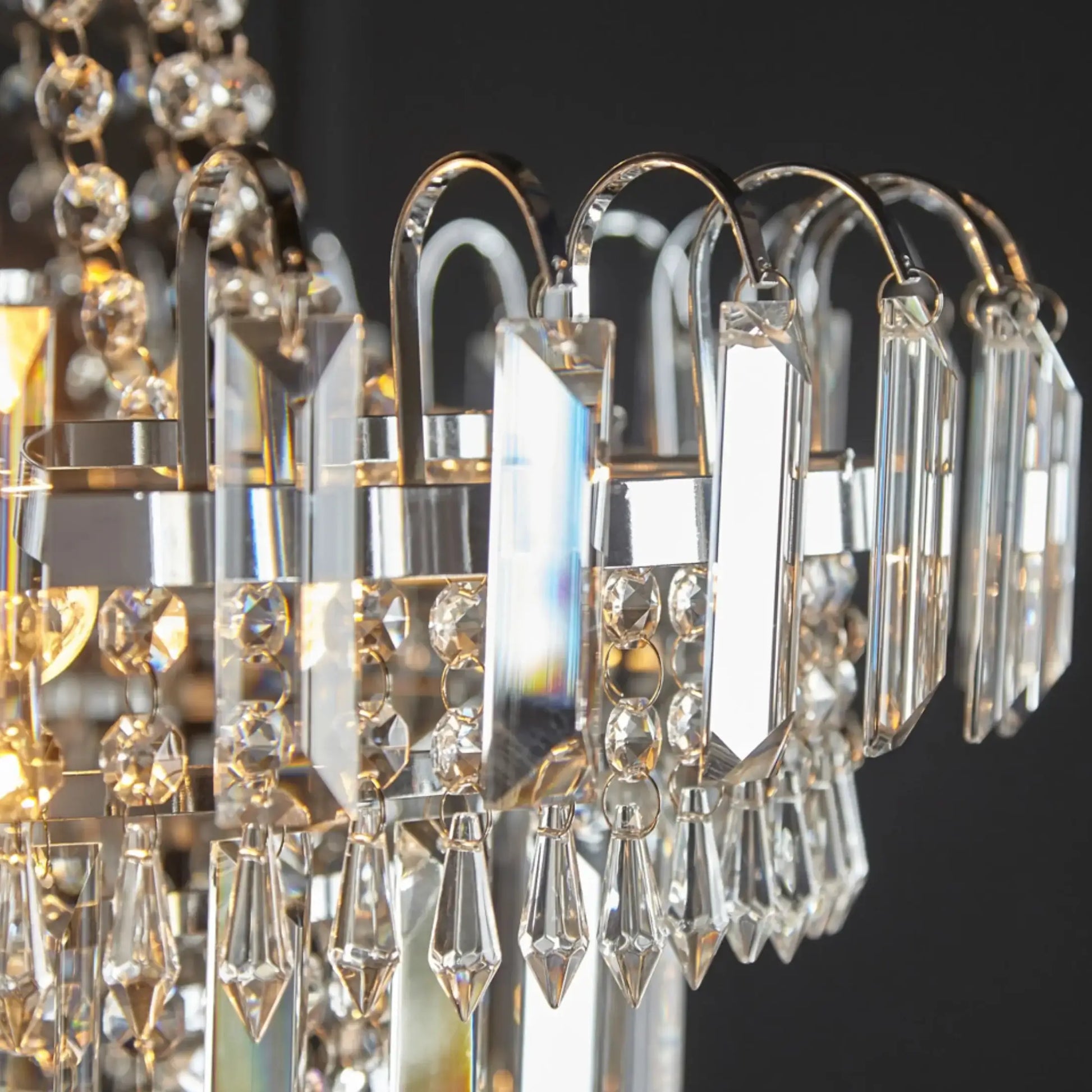 Close-up of a crystal chandelier with clear and gold accents.