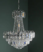 Crystal chandelier hanging against a dark paneled wall