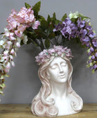 Decorative bust with floral wreath on a wooden surface