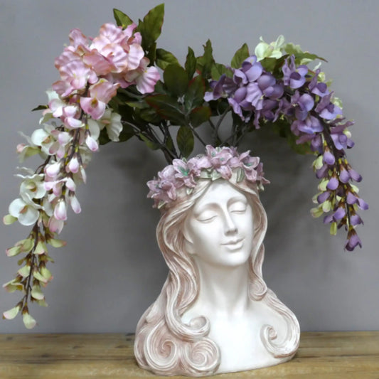 Decorative bust with floral wreath on a wooden surface