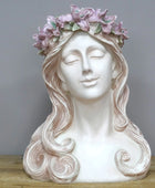 Decorative bust of a woman with a floral crown on a wooden surface and gray background