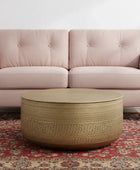 Pink sofa with a woven coffee table on a patterned rug