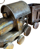 Rustic metal toy train on a wooden surface