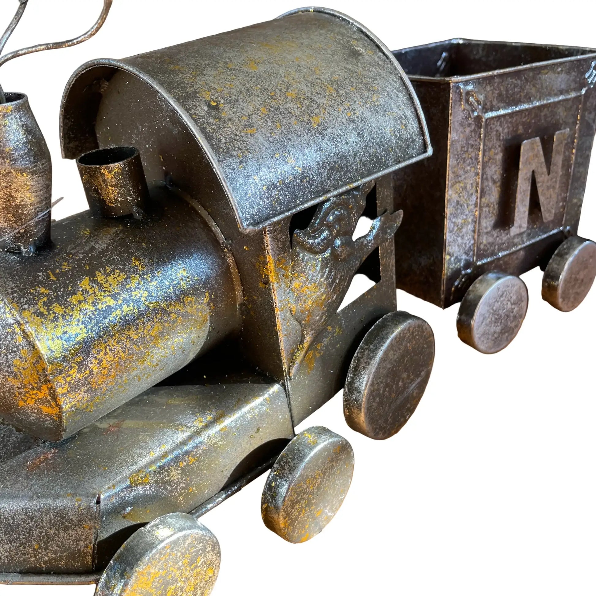Rustic metal toy train on a wooden surface