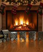 Set of toy train carriages with letter designs on a wooden floor.