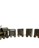 Decorative train set in front of a fireplace with stockings hanging above2