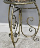Decorative metal table with intricate designs on a neutral background