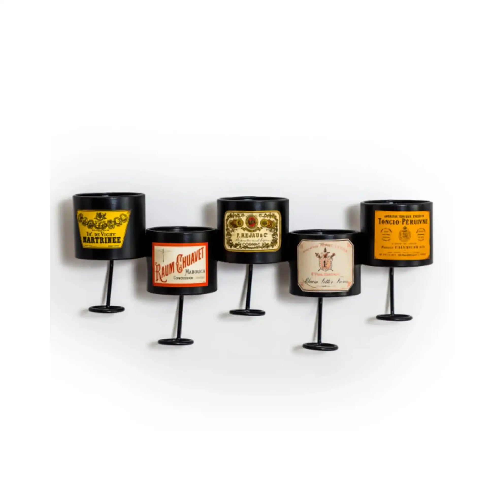 Set of five decorative candle holders with vintage-style labels on a white background