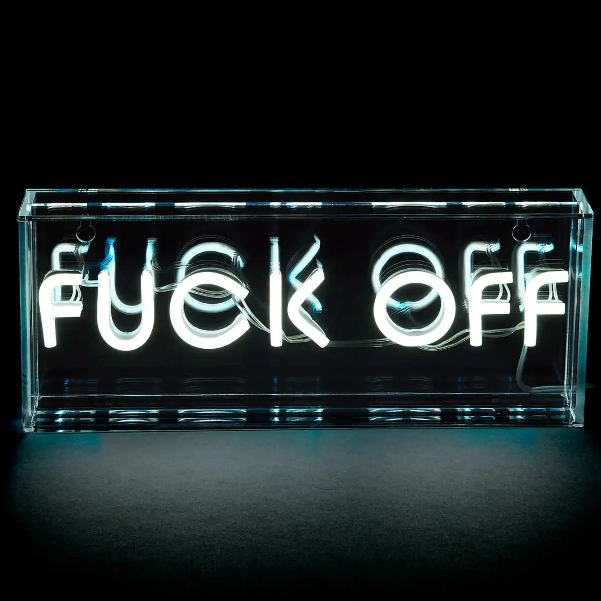 Neon sign with the word 'FUCK OFF' in a clear acrylic box on a black background