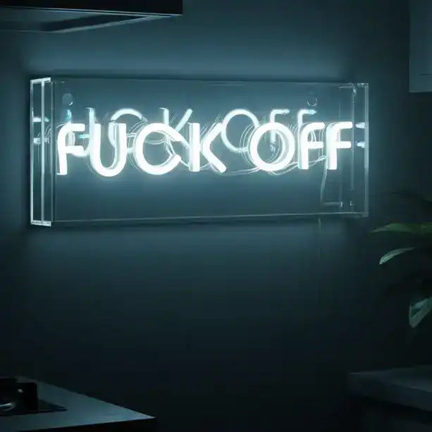 Neon sign with offensive language in a dimly lit room
