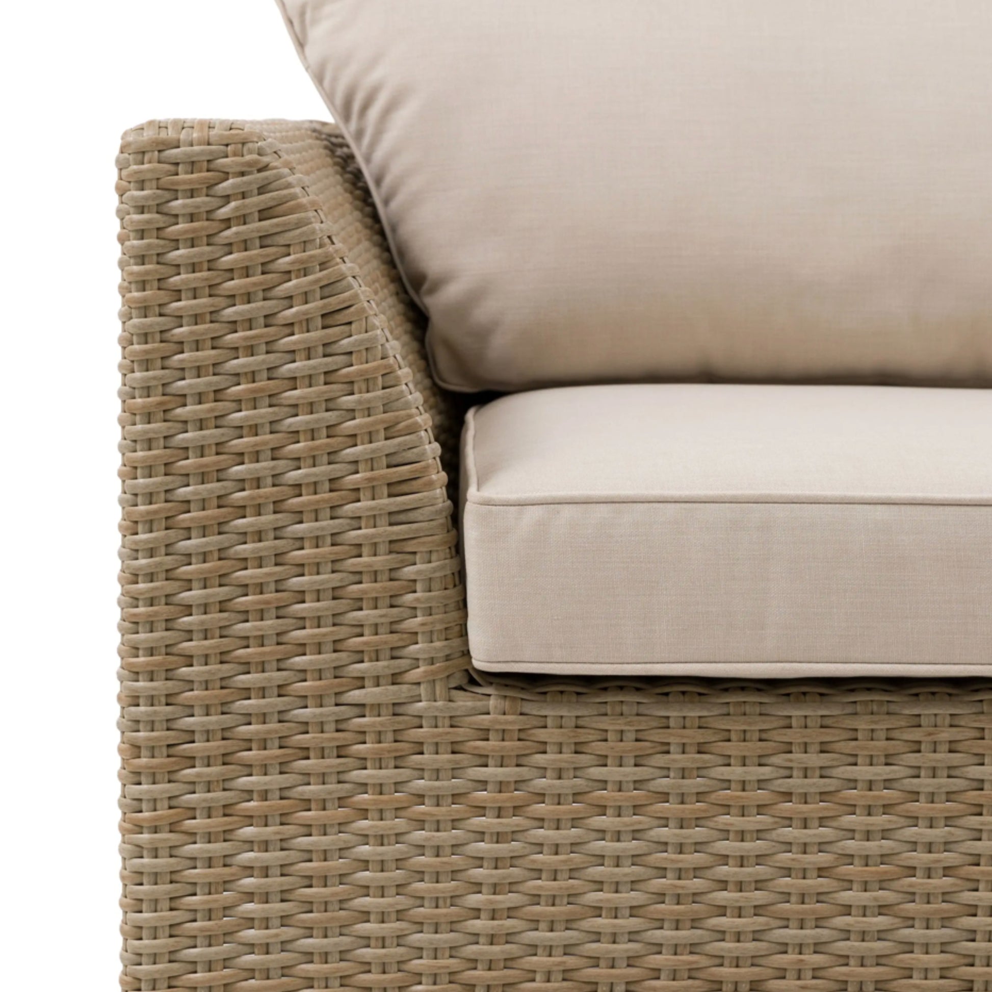 Beige wicker outdoor furniture with beige cushions on a white background