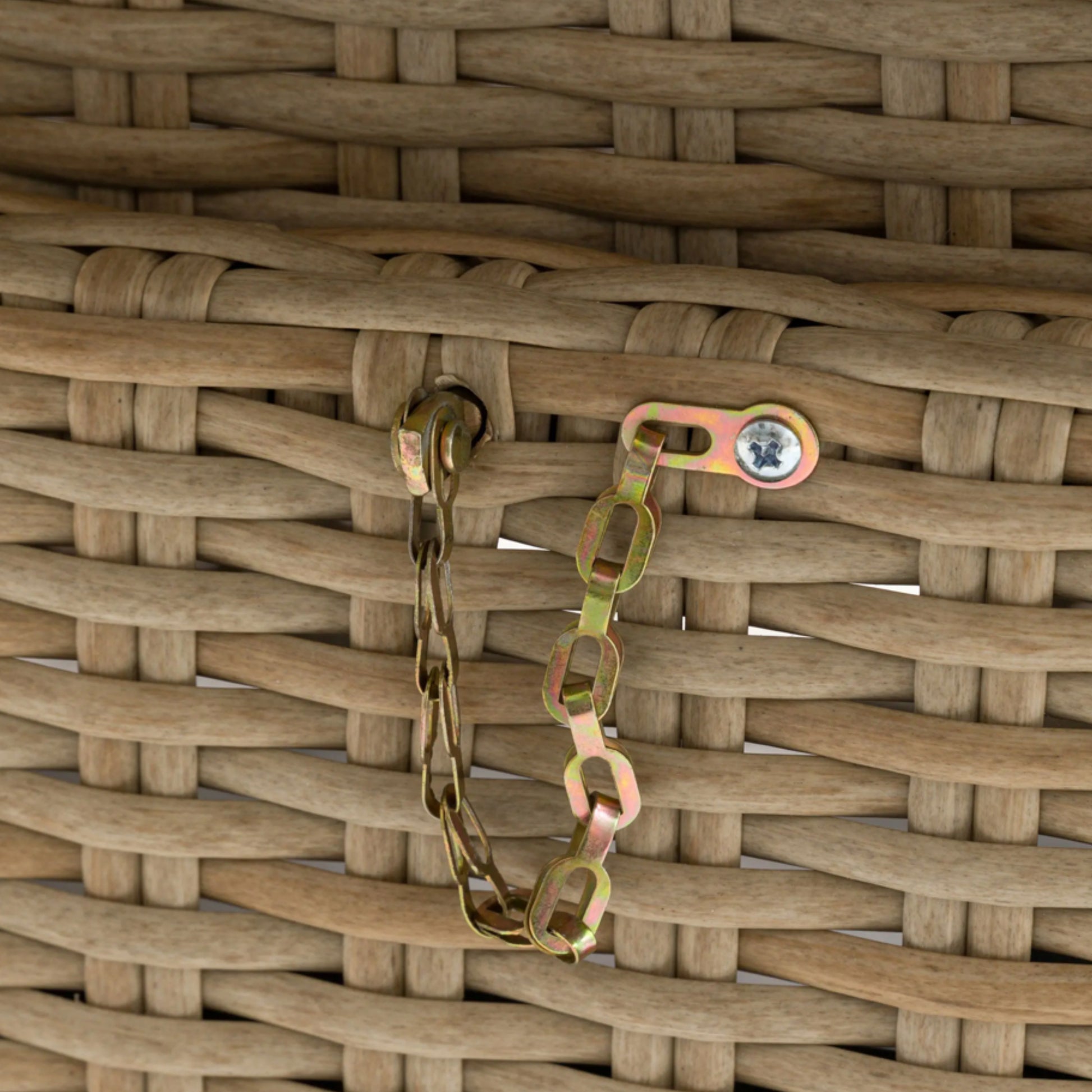 Metal chain with a clasp on a woven brown surface