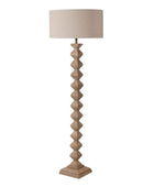 Floor lamp with a textured base and beige lampshade on a white background