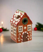 Decorative gingerbread house birdhouse on a white background