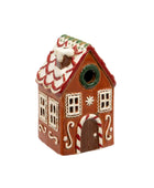 Decorative gingerbread house birdhouse on a white background