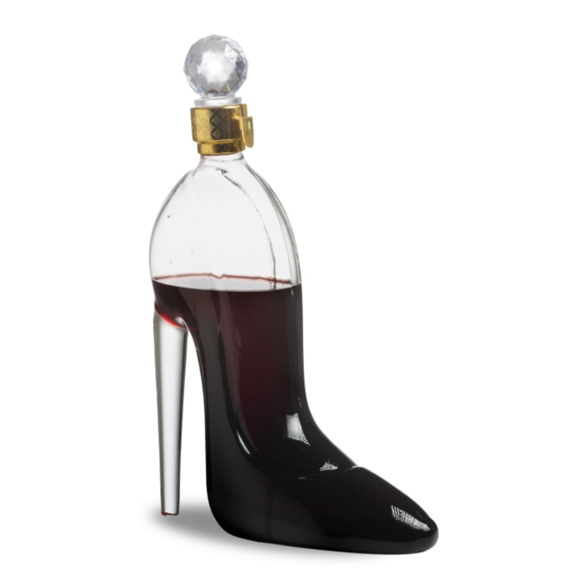 Clear glass bottle shaped like a high-heeled shoe filled with red liquid on a white background
