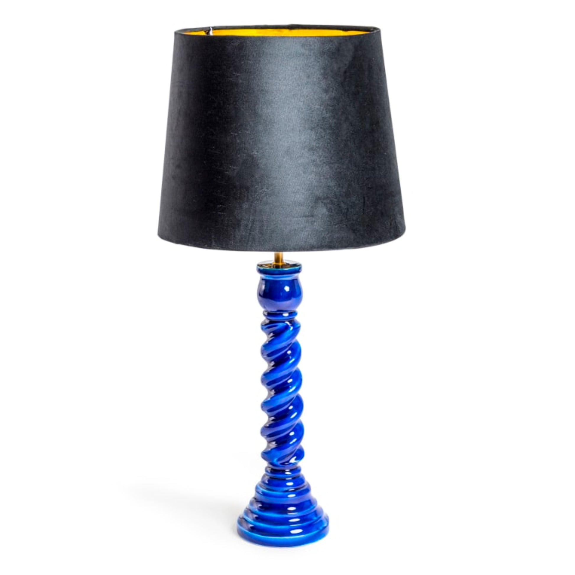 A table lamp with a tapered black fabric shade featuring a gold inner lining, supported by a glossy cobalt blue spiral base on a white background.