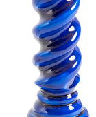 A close-up of a glossy, spiral-shaped blue glass object on a plain white background.