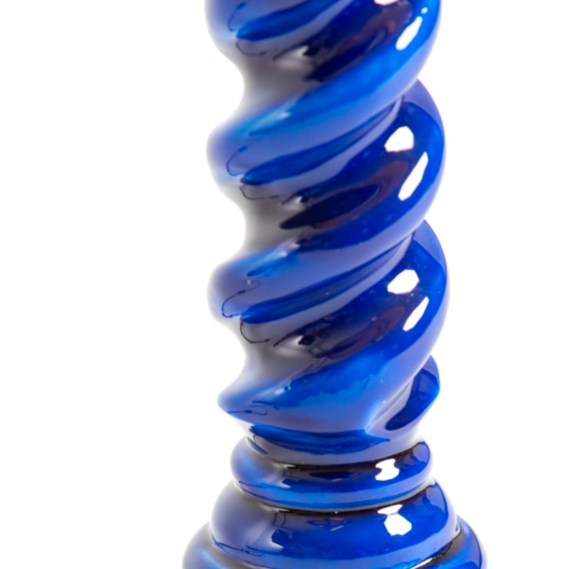 A close-up of a glossy, spiral-shaped blue glass object on a plain white background.