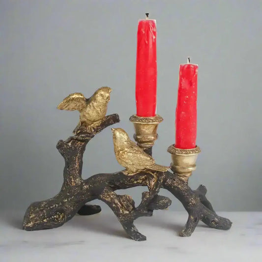 Decorative candle holder with birds and red candles on a white background