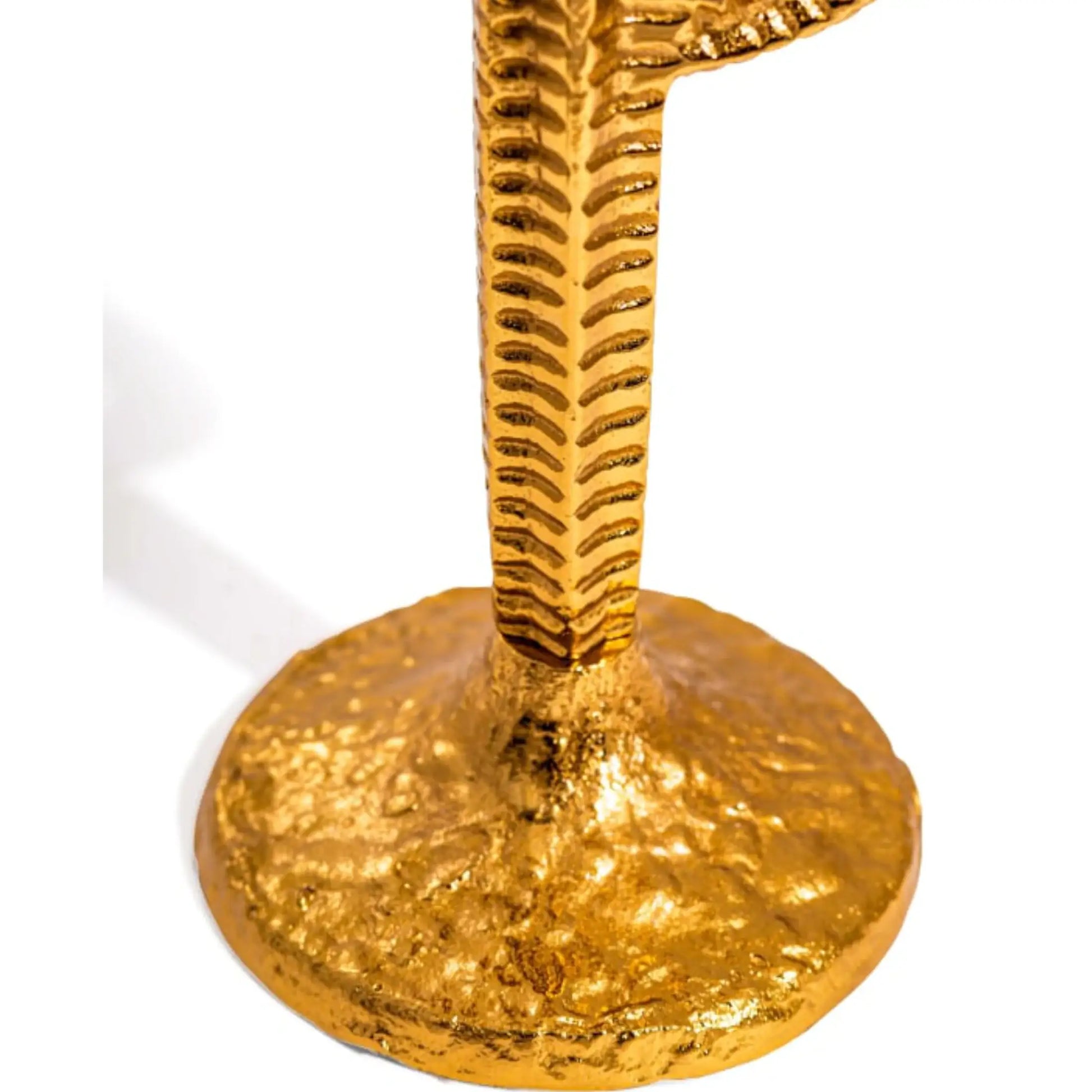 Gold candle holder with textured design on a white background