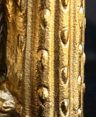 Close-up of a gold decorative object with intricate patterns