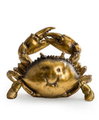 Bronze crab sculpture on a white background