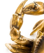 Bronze crab sculpture on a white background