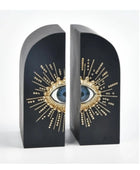 Decorative bookends with eye design on a white background