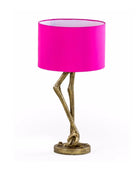 Table lamp with pink shade and gold base on a white background