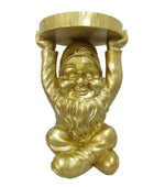 Gold gnome statue holding a round object on a white background