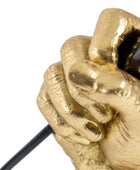 Gold fist holding a black cord against a white background