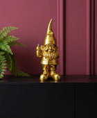 Gold gnome figurine on a white background