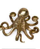Gold octopus candle holder on a white background