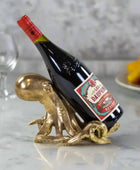 Wine bottle on a decorative brass stand with a white background