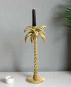 Gold palm tree candle holder on a white background